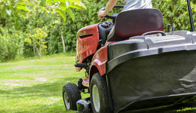 Image of person riding a lawn mower.