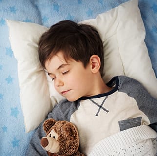 Child sleeping in a bed.