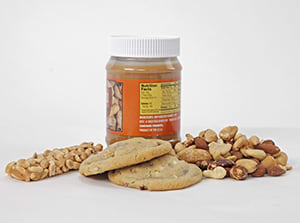 Granola bar, jar of peanut butter, cookies, and mixed nuts.
